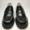 1990s black penny loafers with white trim and chunky soles