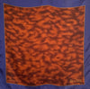 Small square silk pocket scarf  with a blue border, mottled brown center pattern and the word BELAMI on the right bottom corner. 