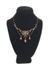 Front view of Victorian era necklace featuring seed pearls and polished coral beads draped on a Black velvet jewelry display neck