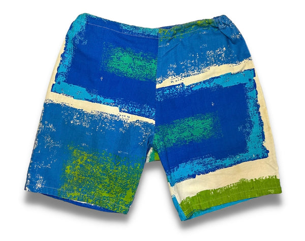 blue, green, and white paint print swim shorts