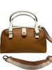 Tan bowler style handbag with white trim and handles. Zipper top and detachable striped cloth shoulder strap