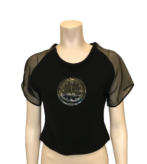 Black polyester/rayon cropped top with sheer nylon sleeves and a plastic patch of a clock face with the words "Time to Create" 