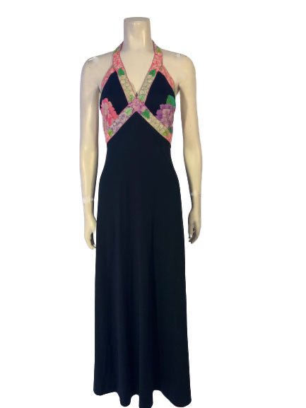 Black, halter-neck, maxi dress with pink and purple floral pattern at the bust. 