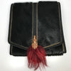 Black leatherr and pony hair fold over handbag with gold clasp and red fur accent and rope shoulder strap