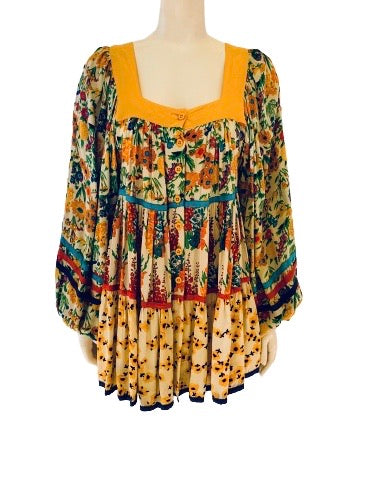 Colorful, tiered, floral mini dress with billowy sleeves and buttons up front. 