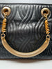 Black leather Fendi handbag with stitched leather body in a wavy pattern. The handles and hardware are in gold-tone metal and chain.