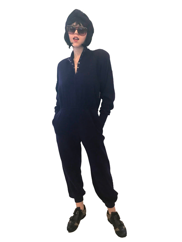 Cotton, fleece-lined, purple, sweatshirt-jumpsuit with snap-front, elasticized-waist, and ribbed cuffs & ankles. 