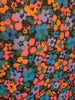 Closeup of Emanuel Ungaro scarf with a floral print in coral, periwinkle, blue, orange, and green.