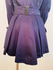 Navy cotton jacket with cropped front and back tails. Front fabric wraps across the body. High neck and cuffed sleeves.