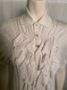White short sleeve top with pointed collar, three buttons and ruffle bib front.