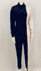 Full length view of mannequin wearing a half black velvet, half white jersey jumpsuit by Norma Kamali.