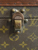 Large, hard, leather suitcase with an all-over “LV” monogram print. Brass hardware with "Louis Vuitton" stamp.