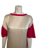 close up image of mannquin bust wearing a tee with pink cotton sleeves and cr��me colored silk facing