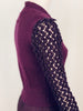 Close up side view of dark purple open crochet sleeves on Jean Paul Gaultier dress.