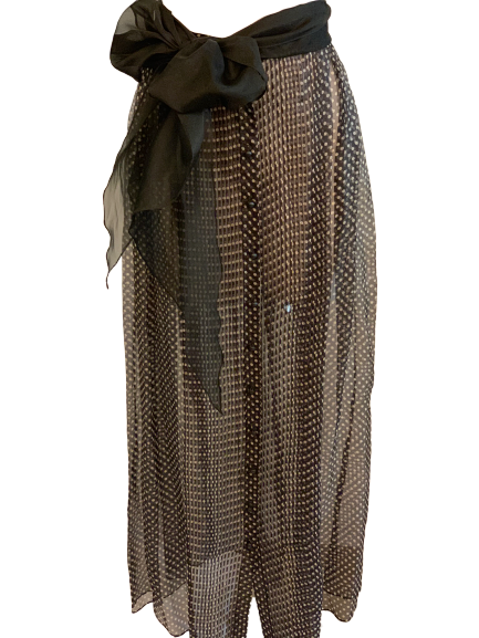 Black with white dots, sheer, maxi-skirt with a large sash at the waistband tied into a bow. 