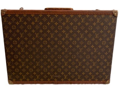 Large, hard, leather suitcase with an all-over “LV” monogram print. Brass hardware.