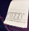 Close up of manufacturer tag 'Fuzzi' in Jean Paul Gaultier purple knit dress.