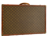 Large, hard, leather suitcase with an all-over “LV” monogram print. Brass hardware with "Louis Vuitton" stamp.