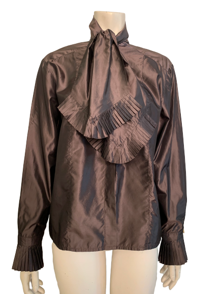Iridescent copper silk blouse with long sleeves and a large bow at neck. Bottom of bow and cuff are trimmed  accordion pleats. Button down front 
