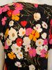 Black, short-sleeve, silk top with a pink, orange, and white floral-print. 