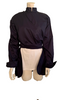 Navy cotton jacket with cropped front and back tails. Front fabric wraps across the body. High neck and cuffed sleeves. 