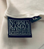 Close up of Norma Kamali tag in jumpsuit. 