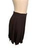 Black, mini-skirt with pleats that run on a diagonal.