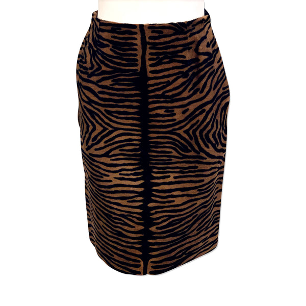 Front view of mannequin wearing brown & black tiger stripe printed pony hair pencil skirt. 