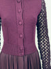Close up front view of dark purple wool knit top with knit buttons and draped rayon skirt on Jean Paul Gaultier dress.
