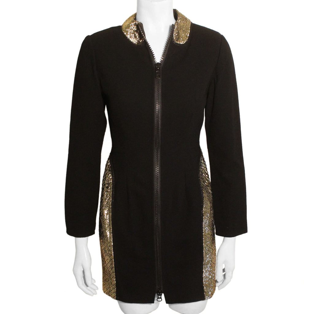 Full length front view of mannequin wearing Geoffrey Beene black wool zip-up mini dress with gold metallic quilted sides. 